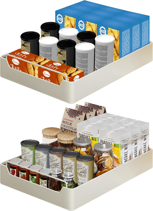 Two pull-out cabinet organizer trays with various kitchen items neatly arranged on them, indicating a tidy and organized pantry.