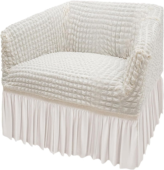 A cream white armchair stretch slipcover on a chair, showcasing a textured and breathable fabric with a skirt at the bottom.